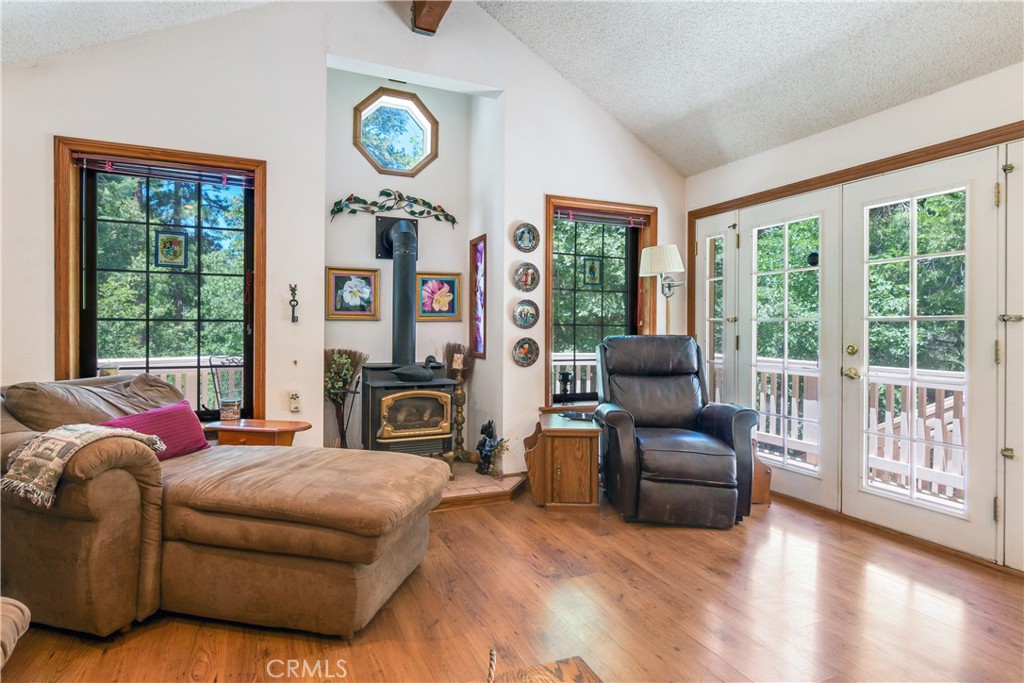 9339 Wood Road Forest Falls, CA 92339 - Photo 21 of 48 a living room with furniture a fireplace and a floor to ceiling window