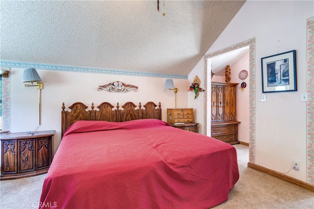 9339 Wood Road Forest Falls, CA 92339 - Photo 31 of 48 a bed room with a bed and a painting on the wall