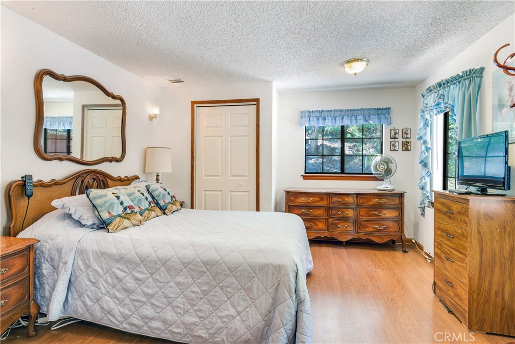 9339 Wood Road Forest Falls, CA 92339 - Photo 38 of 48 a bedroom with a bed and wooden floor