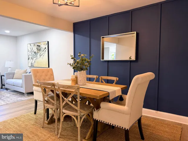 a dining room with furniture and wooden floor