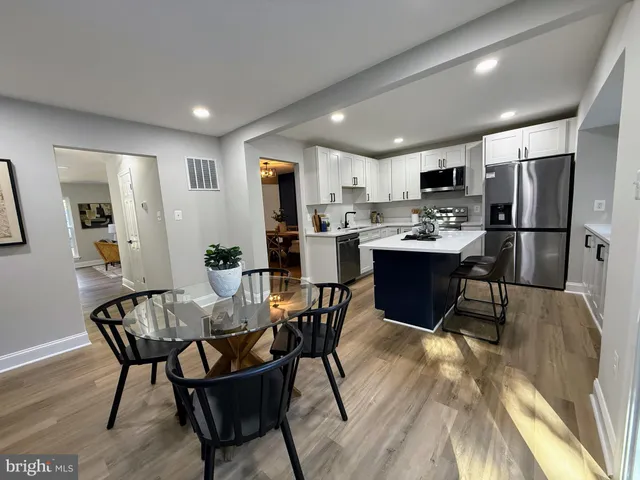 a view of a dining room with furniture and a kitchen