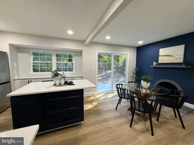 a dining room with a table chairs and a flat screen tv