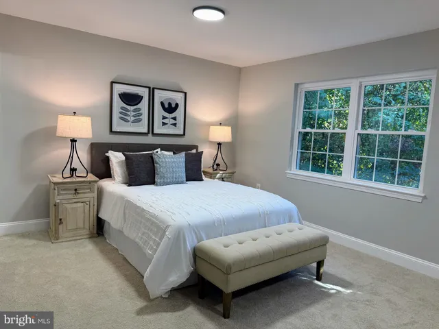 a bedroom with bed and window