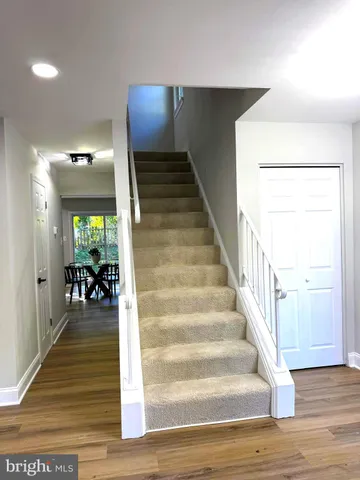 a view of entryway and hall with wooden floor