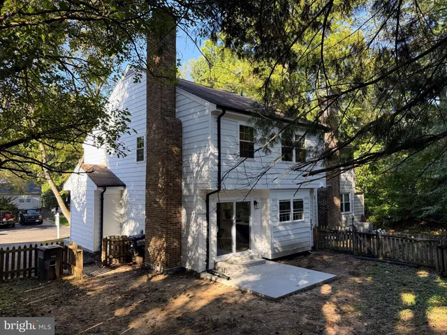 a front view of a house with a tree in it