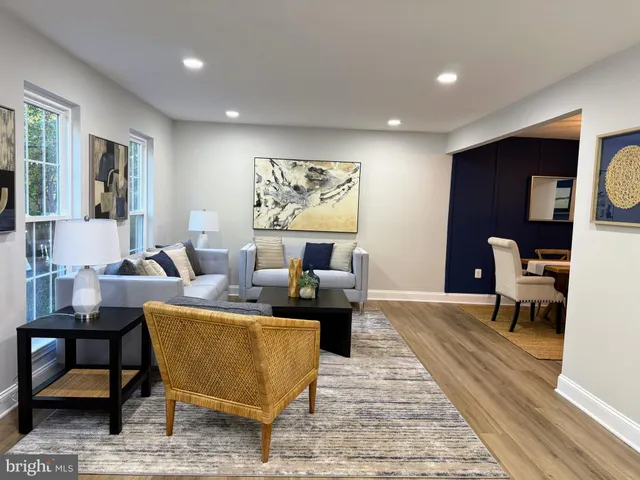 a living room with furniture a rug and a table
