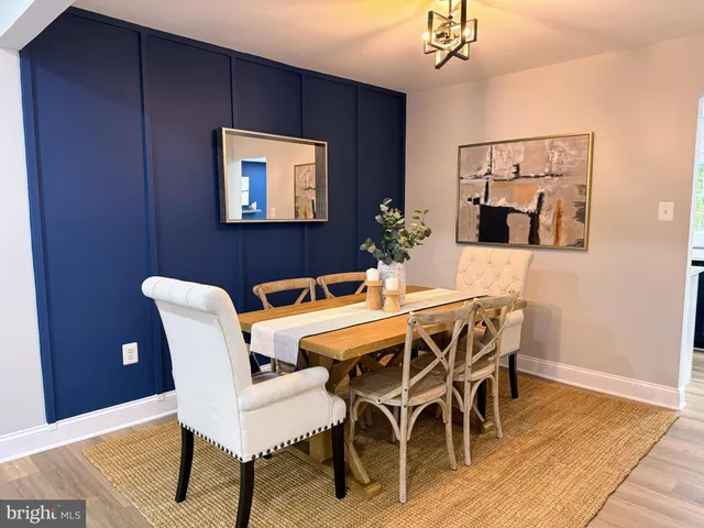 a dining room with furniture and wooden floor