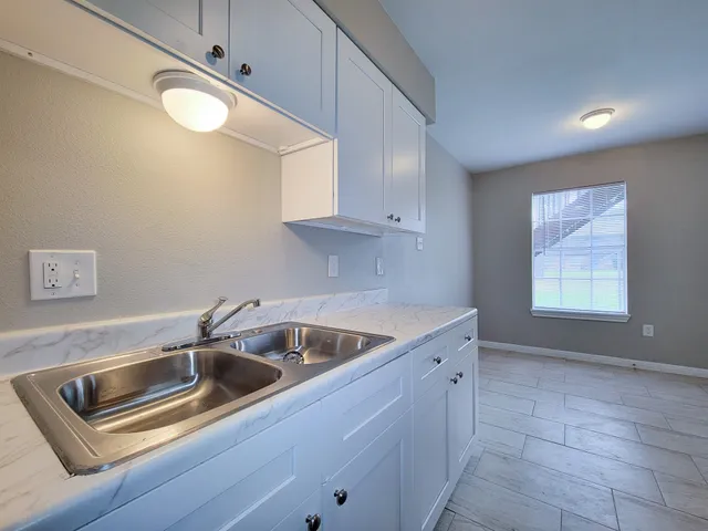 a kitchen that has a sink and cabinets