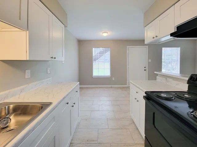 a kitchen that has a sink and a stove