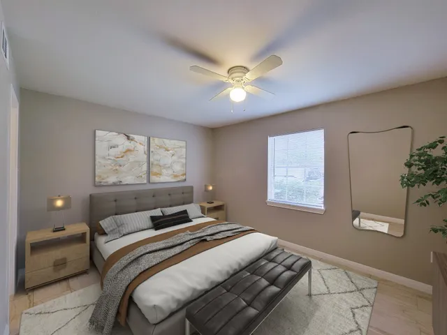 a bedroom with a large bed and a chandelier