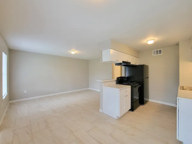 a kitchen with stainless steel appliances a refrigerator and a stove top oven