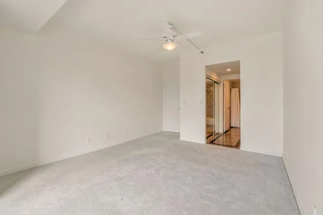 an empty room with windows and entrance