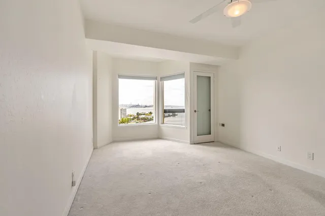 a bathroom with a granite countertop sink a mirror a vanity and bathtub