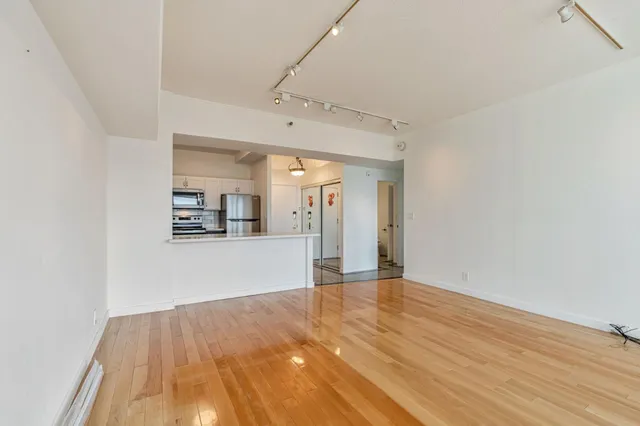 a view of a kitchen with wooden floor