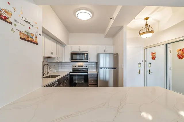 a kitchen with a sink cabinets and wooden floor