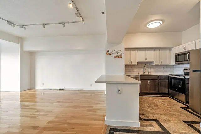 a kitchen with cabinets a sink and stainless steel appliances