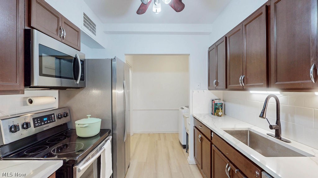 13800 Fairhill Road, Unit 203 Cleveland, OH 44120 - Photo 8 of 28 Kitchen featuring updated cabinets, quartz counters and updated stainless steel appliances.
