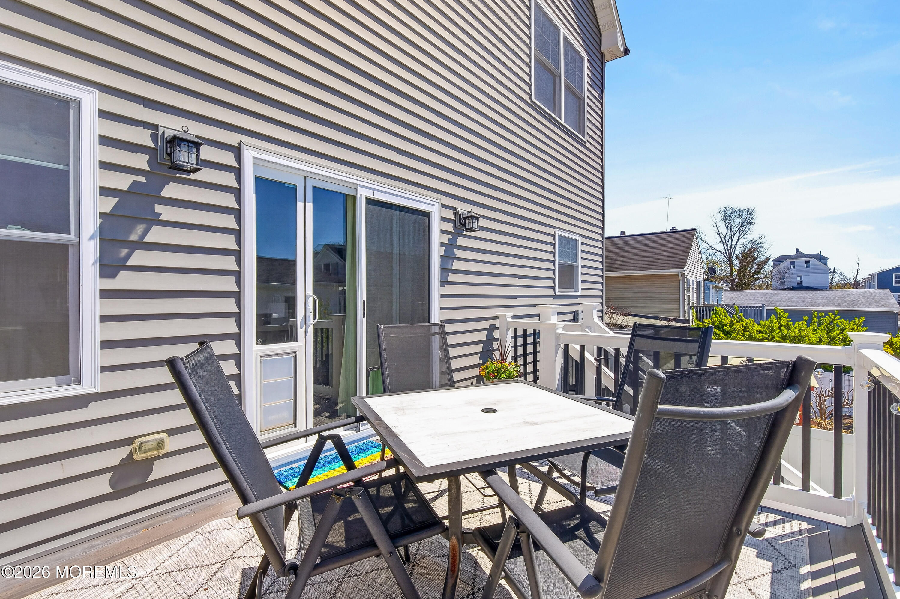 27 5th Street Highlands, NJ 07732 - Photo 58 of 62 a view of a dinning tables and chairs in patio of the house