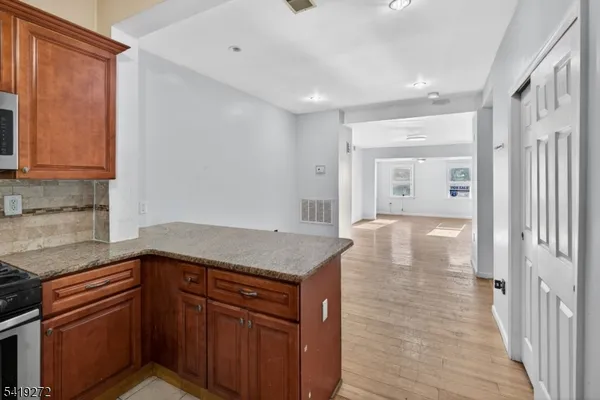 a kitchen with a sink dishwasher and wooden cabinets