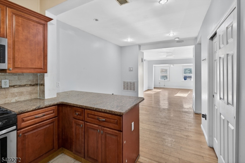 136 Smith Street Elizabeth, NJ 07201 - Photo 14 of 45 a kitchen with a sink dishwasher and wooden cabinets