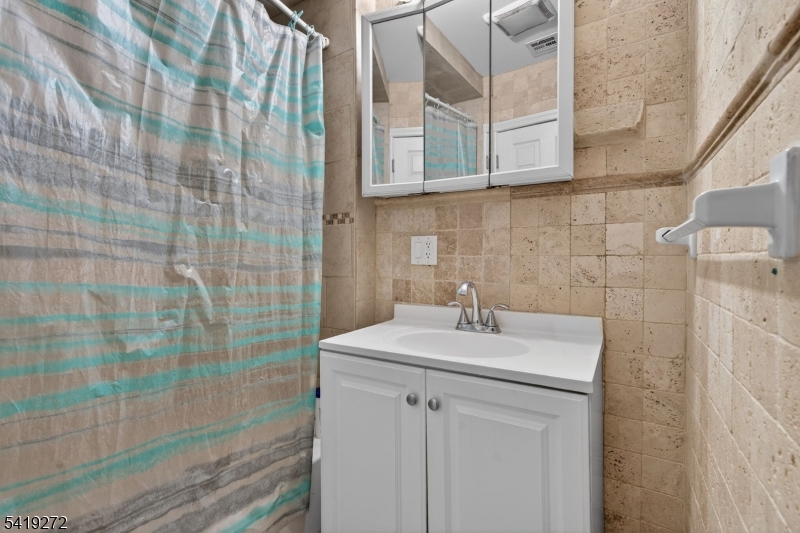 136 Smith Street Elizabeth, NJ 07201 - Photo 19 of 45 a bathroom with a sink a toilet and shower