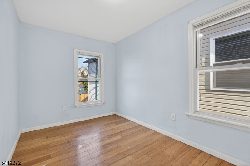 136 Smith Street Elizabeth, NJ 07201 - Photo 28 of 45 a view of an empty room with wooden floor and a window