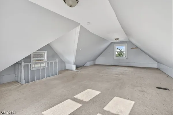 a view of a big room with staircase and hallway