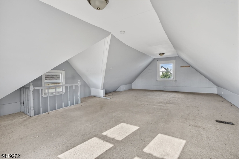 136 Smith Street Elizabeth, NJ 07201 - Photo 32 of 45 a view of a big room with staircase and hallway
