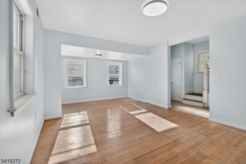 136 Smith Street Elizabeth, NJ 07201 - Photo 6 of 45 an empty room with wooden floor and windows