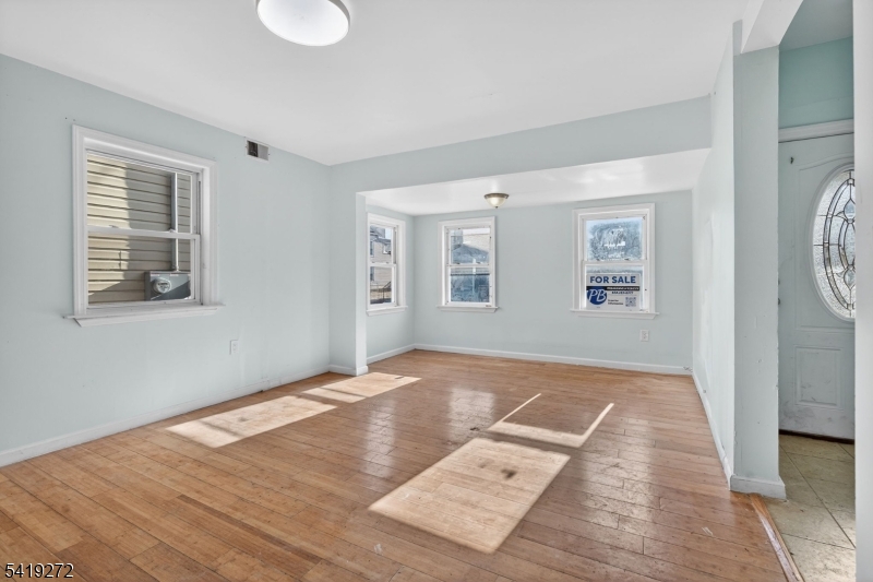 136 Smith Street Elizabeth, NJ 07201 - Photo 7 of 45 a view of an empty room with wooden floor and a window