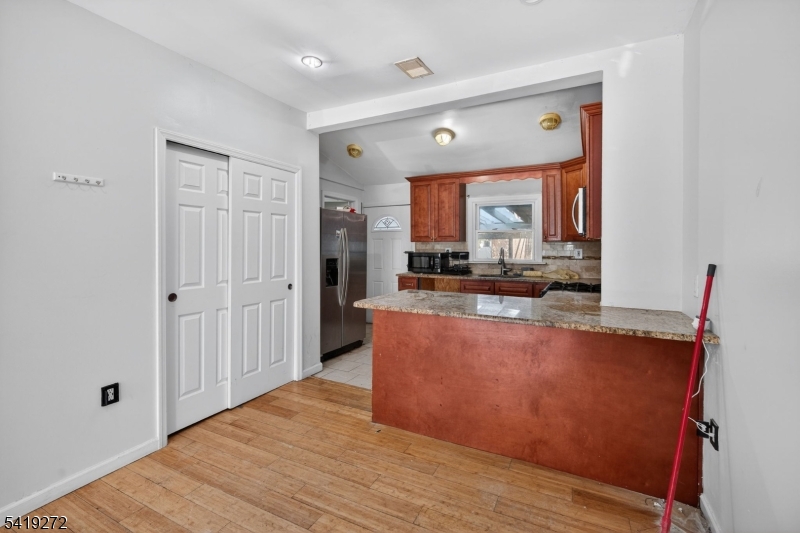 136 Smith Street Elizabeth, NJ 07201 - Photo 9 of 45 a living room with stainless steel appliances wooden floor and a large window