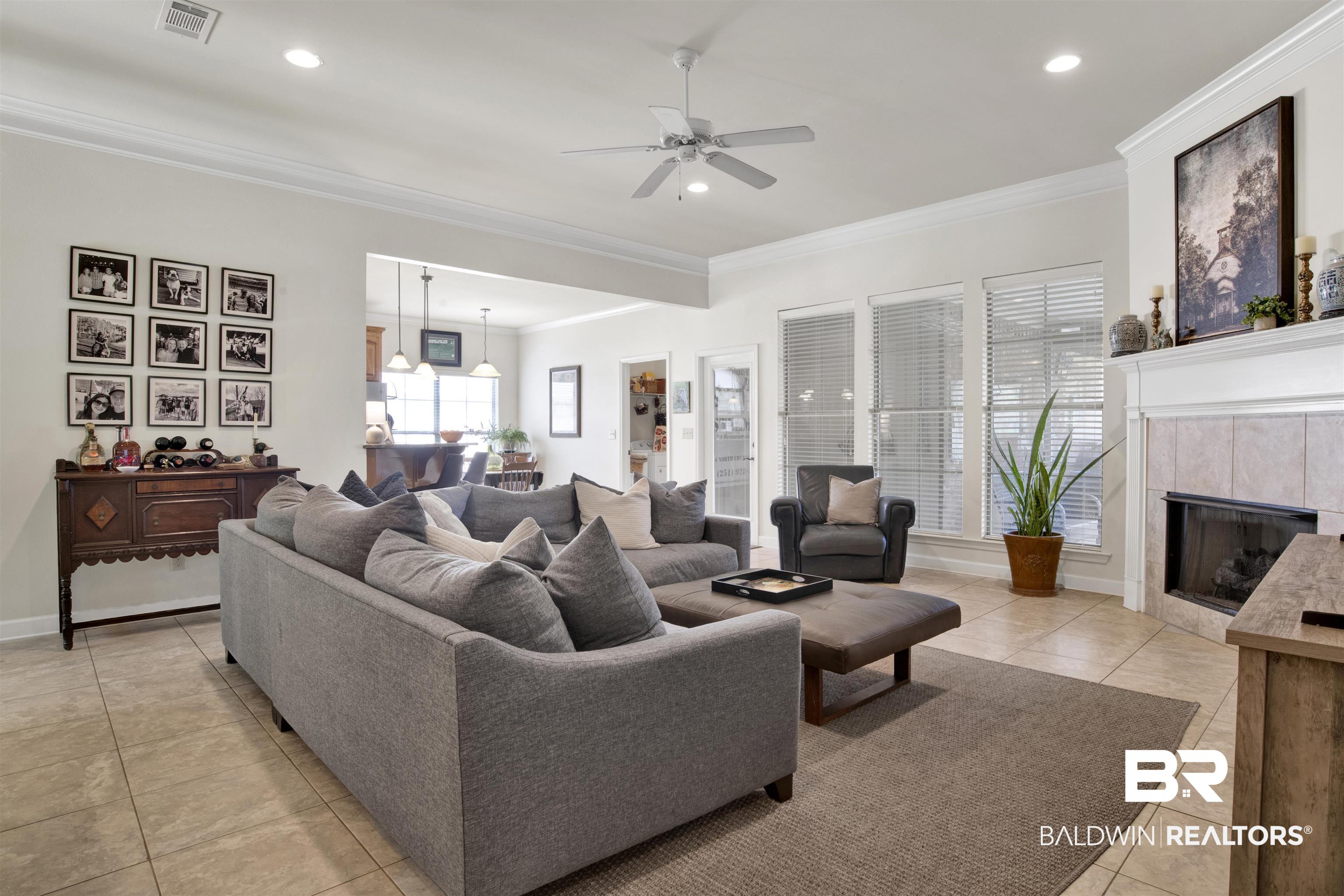 10368 Gayfer Rd Extension Fairhope, AL 36532 - Photo 3 of 43 Spacious living area featuring neutral-toned tile flooring, recessed lighting, and crown molding