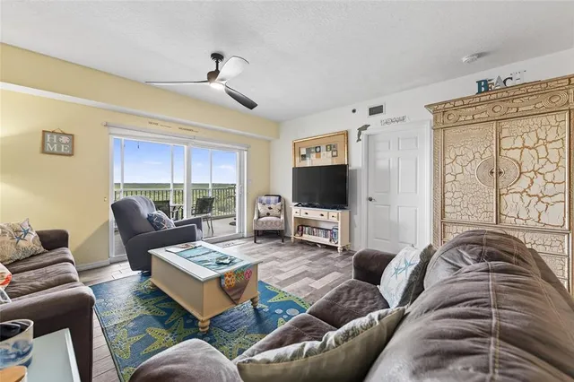 a kitchen that has a sink a stove top oven a refrigerator and a dining table with granite countertops