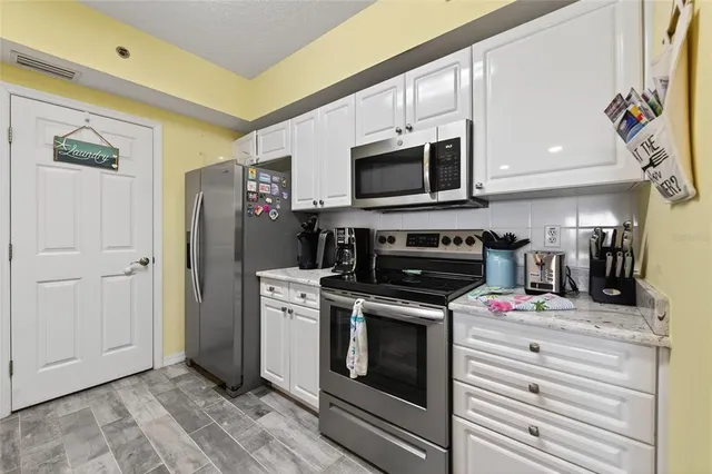 a bedroom with a bed a large window and flat screen tv