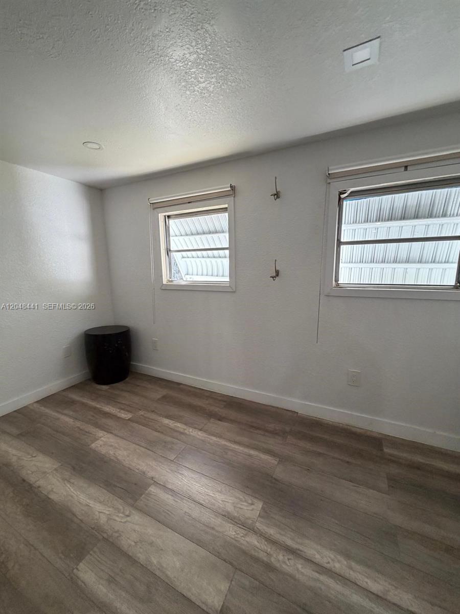 5331 Southwest 35th Street Davie, FL 33314 - Photo 19 of 31 a view of an empty room with wooden floor and a window