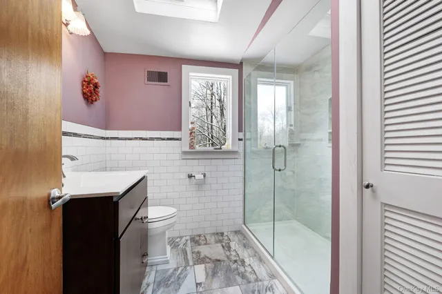 a view of a patio with table and chairs with wooden fence and floor