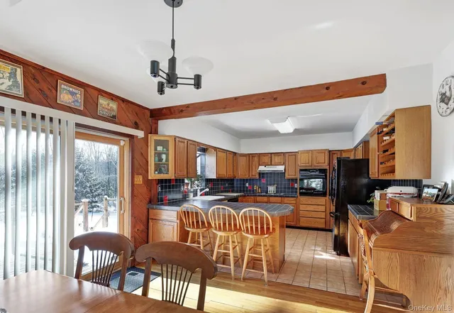 a dining room with furniture entryway and wooden floor