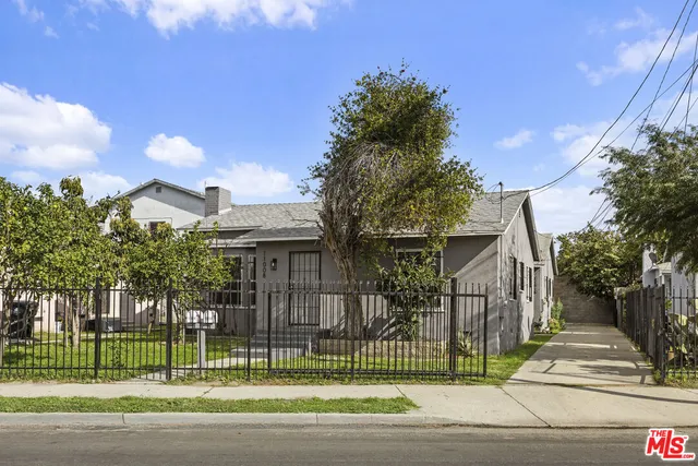 a view of a house with a garden and a plants