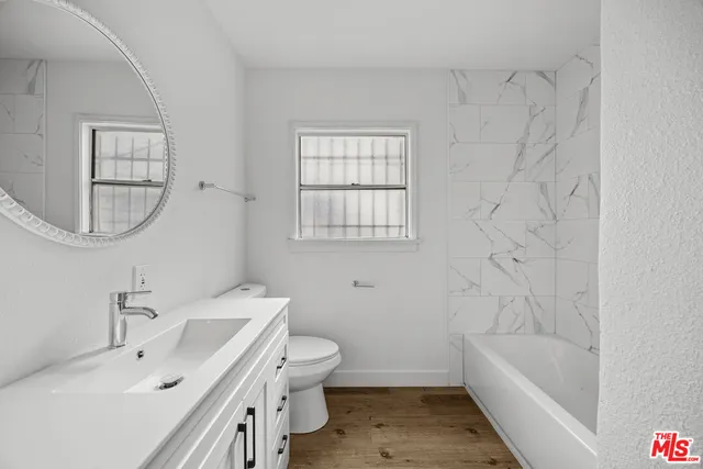 a bathroom with a sink a toilet and bathtub