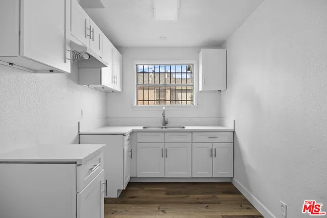 a kitchen with sink cabinets and window