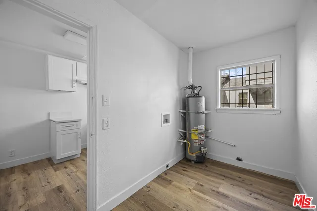 a view of empty room with windows and wardrobe