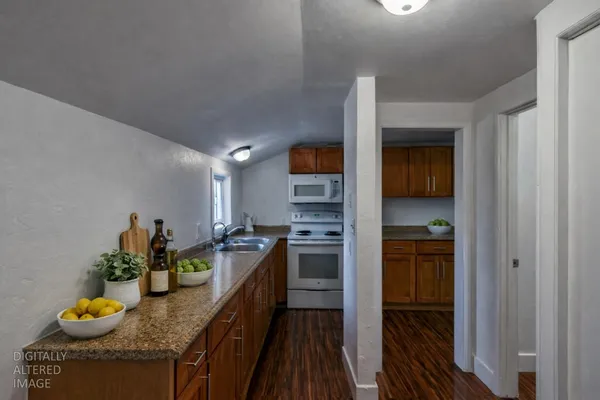 a kitchen with granite countertop lots of counter top space and stainless steel appliances