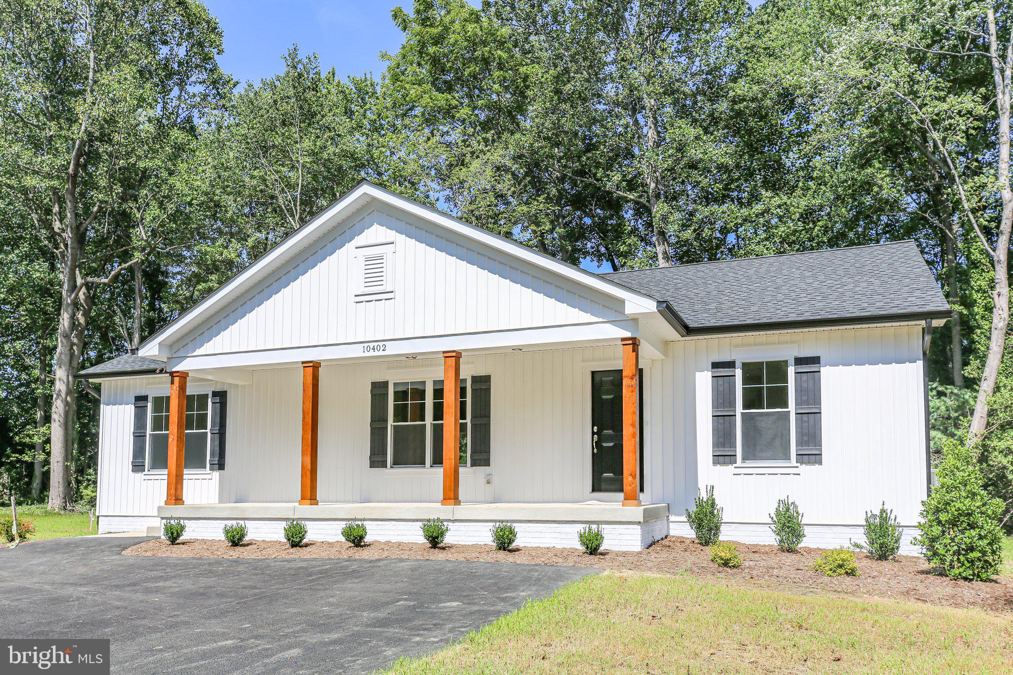1145 Mathias Point Road King George, VA 22485 - Photo 12 of 39 a front view of a house with a garden