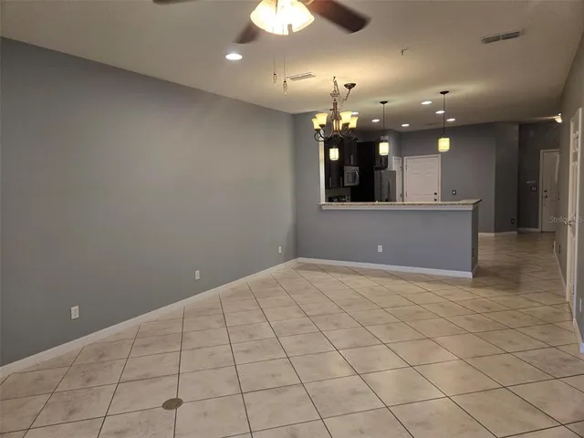 wooden floor in an empty room with a kitchen