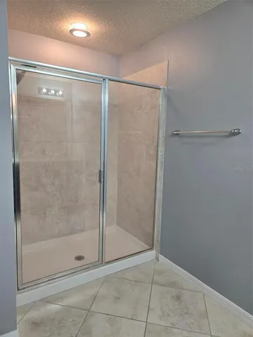 a bathroom with a glass shower door