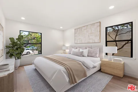 a bedroom with a large bed and a couch