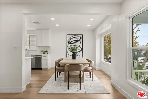 a view of a dining room with furniture and window