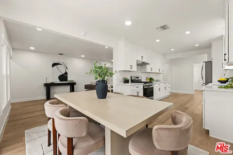 a kitchen with a table and chairs