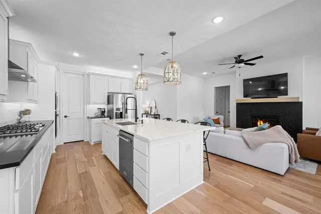 a large white kitchen with sink stove and refrigerator