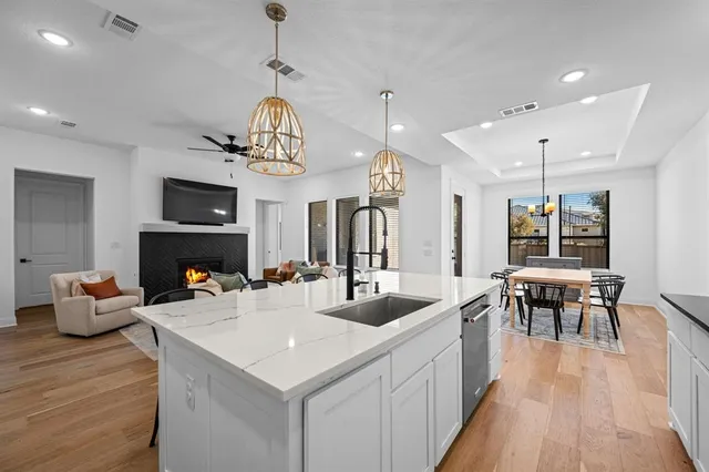 a view of dining table and chairs in a room with kitchen view
